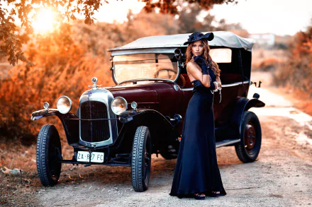 A brunette woman in a blue dress and hat poses beside a vintage car in an outdoor setting, creating a classic and elegant HD desktop wallpaper.