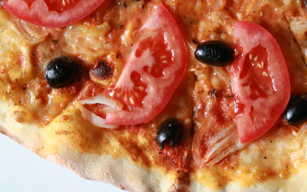 Close-up of a pizza topped with melted cheese, sliced tomatoes, and black olives, presented as a 4K Ultra HD PC desktop wallpaper.
