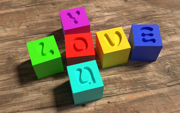 HD desktop wallpaper featuring colorful cubes with carved letters spelling LOVE on a wooden surface. Tags include colors, cube, artistic, love.