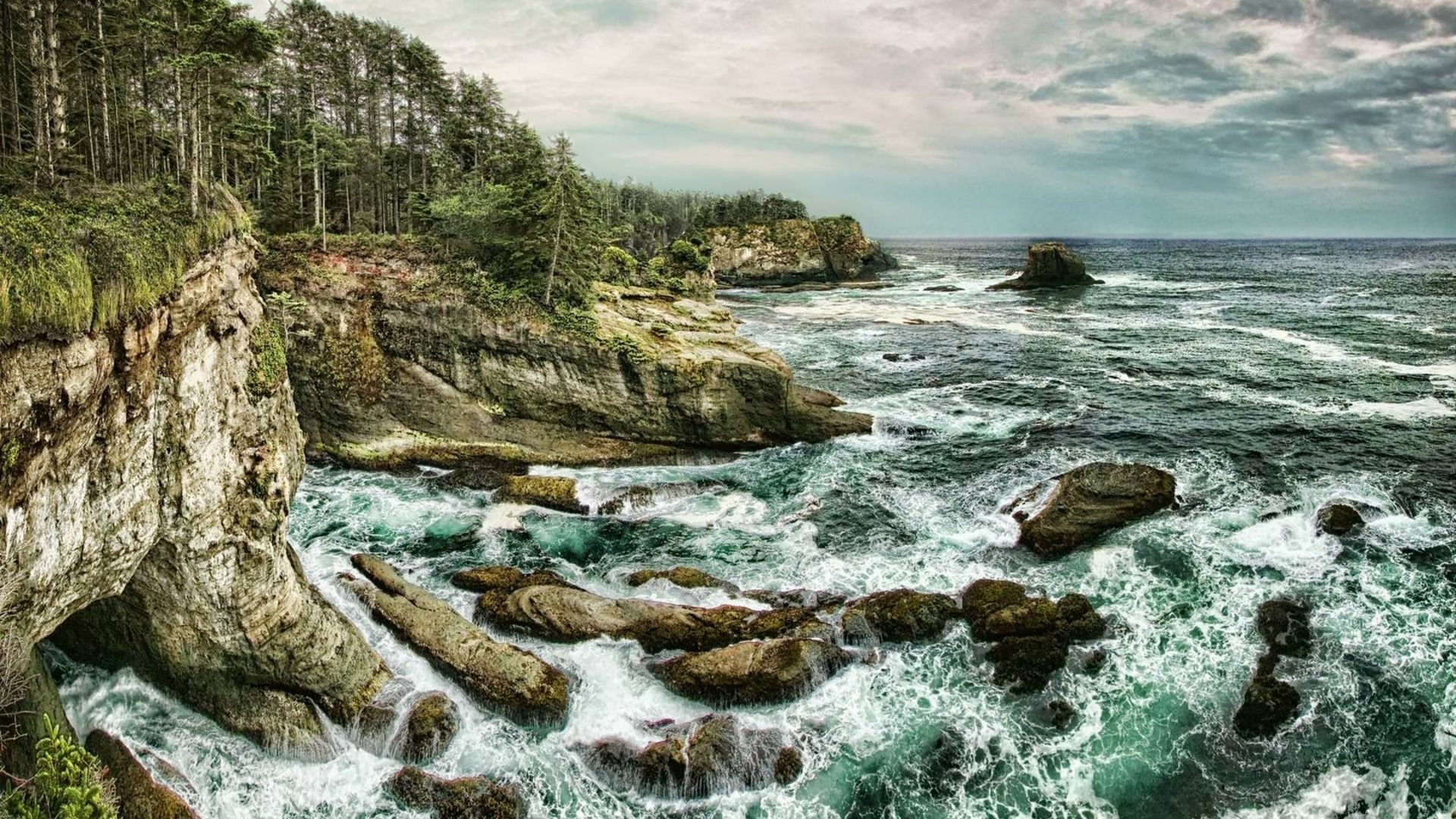 A breathtaking coastline view showcasing rugged cliffs, crashing ocean waves, and a dramatic horizon, enriched by vibrant HDR colors. This natural landscape captures the essence of coastal beauty.