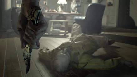 HD PC desktop wallpaper from Resident Evil 7: Biohazard featuring Ethan Winters holding a knife with a blurred figure lying on the floor in the background.