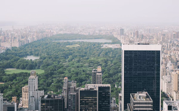 4K Ultra HD PC desktop wallpaper and background: aerial view of Central Park's green expanse framed by man-made New York City skyscrapers in the USA.