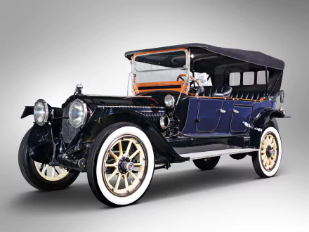 HD PC desktop background: vintage 1914 Packard Six Phaeton open touring vehicle, dark blue body, whitewall tires and black folding top.