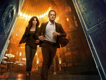 HD PC desktop wallpaper featuring Felicity Jones and Tom Hanks in a dramatic scene from the movie Inferno, set against a glowing, ornate background.