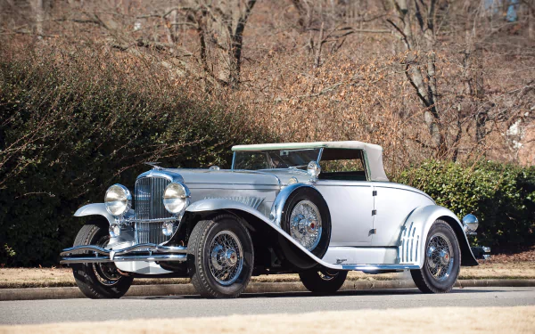 A pristine 1929 Duesenberg Model J Convertible Coupe vintage car displayed outdoors, captured in 4K Ultra HD quality as a classic vehicle wallpaper.