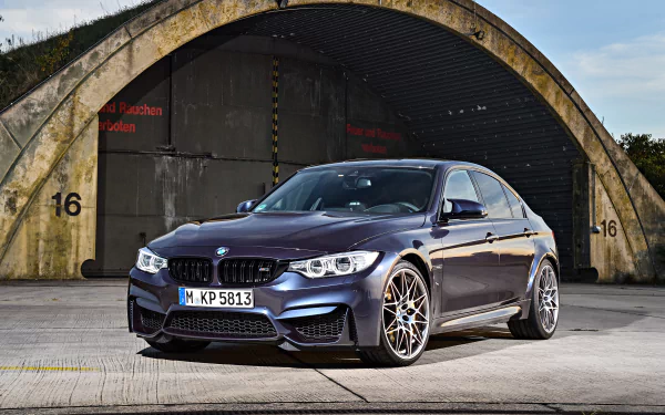 A sleek purple BMW M3 parked in front of a concrete arch, captured in sharp detail as a 4K Ultra HD desktop wallpaper and background.