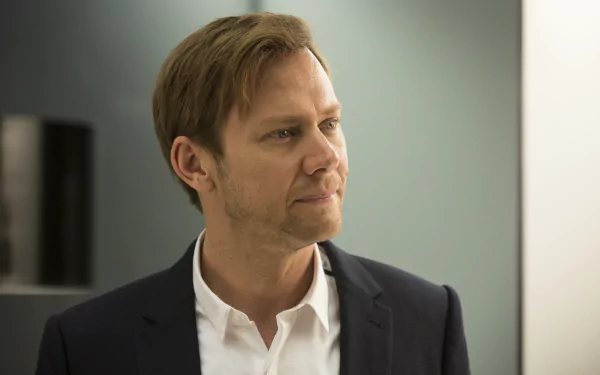 HD wallpaper featuring Jimmi Simpson as William from the TV show Westworld, capturing a moment of intensity with a contemplative expression against a minimalist background.