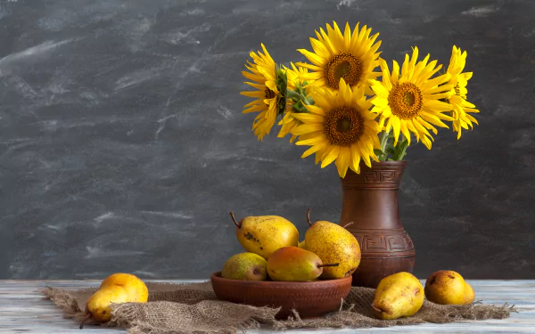 8K Ultra HD desktop wallpaper: still life of bright yellow sunflowers in a ceramic vase beside a bowl of pears on a rustic table.