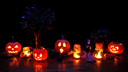 A collection of carved jack-o'-lanterns glowing against a dark background, surrounded by candles and leaves, creating a festive Halloween atmosphere in 4K Ultra HD.