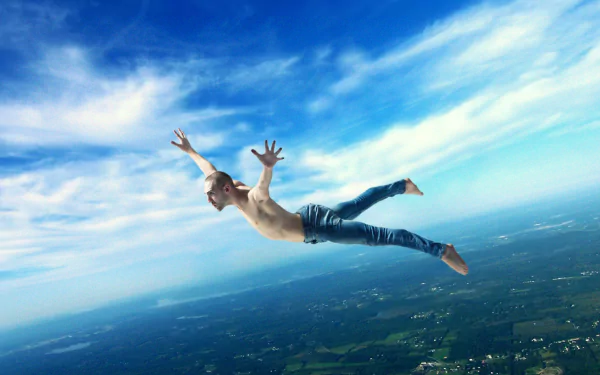 HD PC desktop wallpaper/background: a photoshop photography manipulation of a shirtless man falling through a bright blue sky above a patchwork countryside.