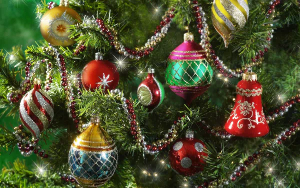 Vibrant colorful Christmas ornaments decorate a lush holiday tree with sparkling lights and garlands, creating a festive HD desktop wallpaper background.