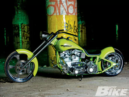 A vibrant yellow Harley-Davidson chopper motorcycle parked indoors, featured as an HD PC desktop wallpaper and background.