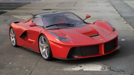 HD desktop wallpaper featuring a red Ferrari LaFerrari supercar parked on a concrete surface, showcasing sleek design and high-performance vehicle details.