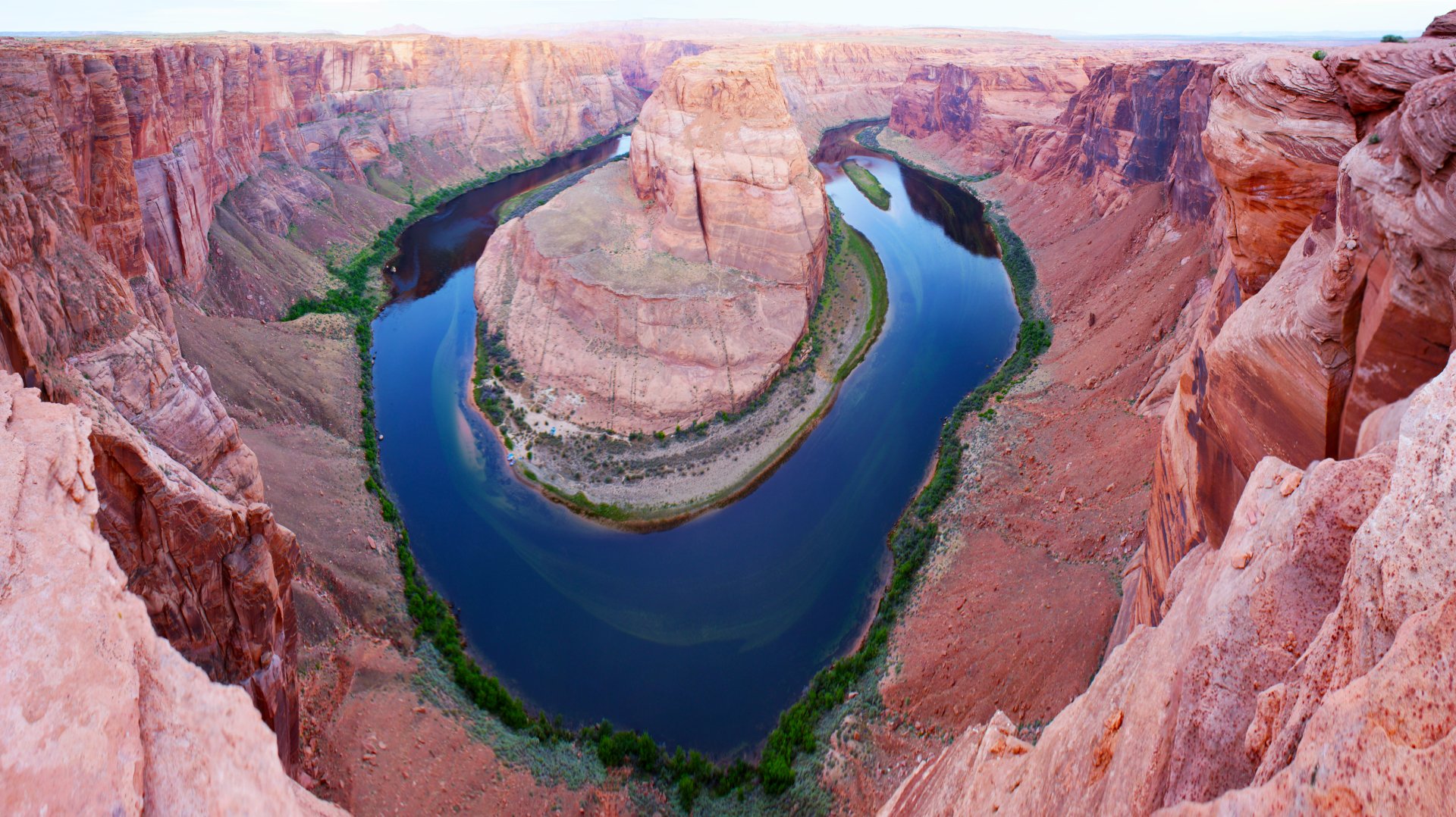 A 4K Ultra HD image of Horseshoe Bend, a winding river flowing through a striking canyon landscape in Arizona.