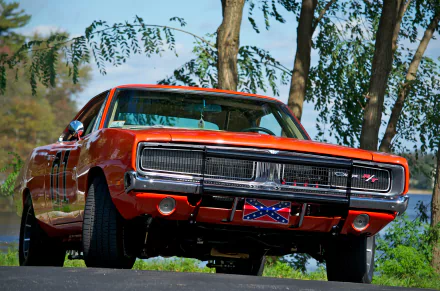 4K Ultra HD PC wallpaper showing a bright orange General Lee hot rod vehicle, front view parked by trees, with its grille and Confederate flag visible on the roof.