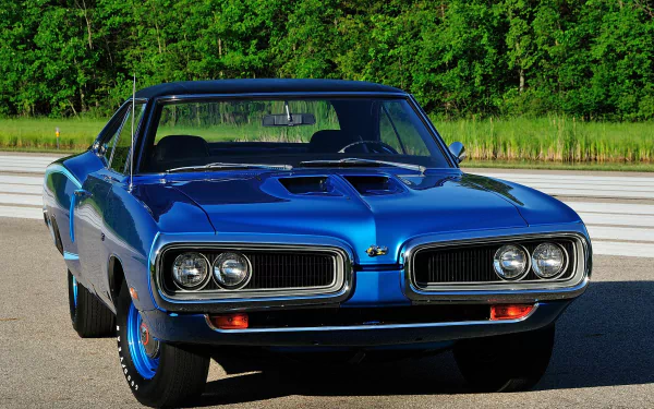 Blue Dodge Coronet Super Bee hardtop coupe parked on road, framed by green trees — HD PC desktop wallpaper/background featuring a classic Dodge Coronet muscle car.