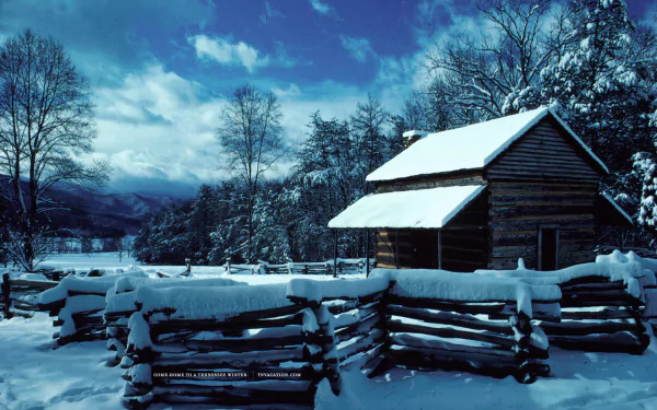 Snow-covered wooden house and fence in a wintery Tennessee landscape under a bright blue sky, captured in stunning HD photography.