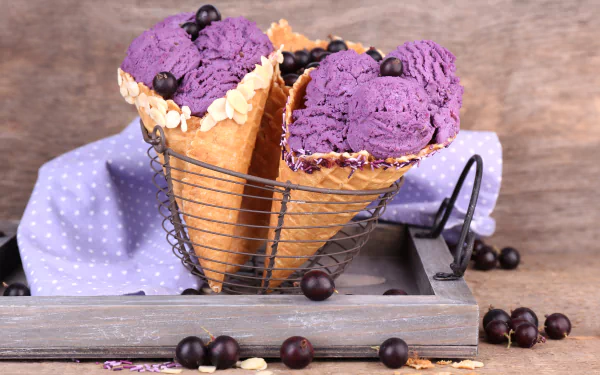 A 4K Ultra HD still life image of two waffle cones filled with vibrant purple ice cream, garnished with small blackcurrants, set against a rustic wooden background.