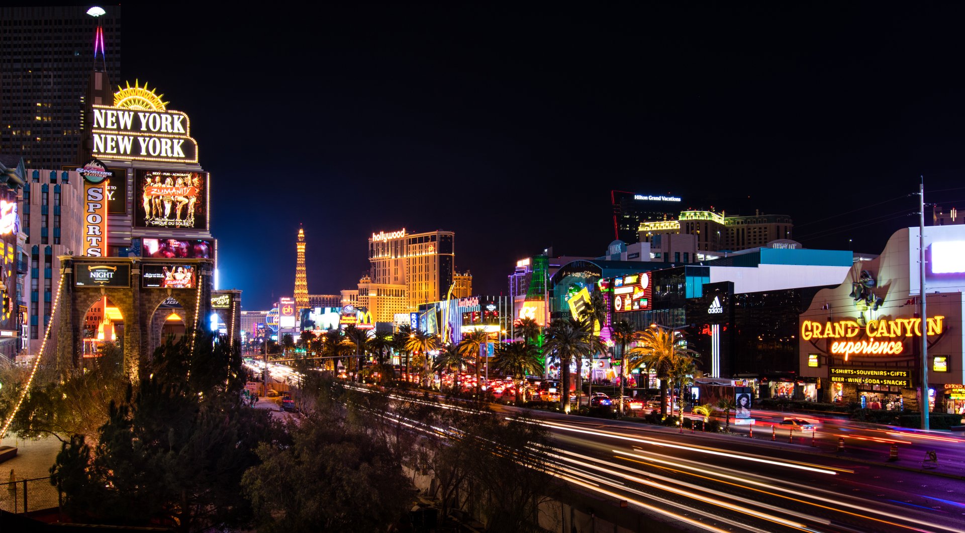 Nighttime 4K Ultra HD view of brightly lit buildings, streets, and roads in the city of Las Vegas, USA, showcasing vibrant man-made lights and urban energy.