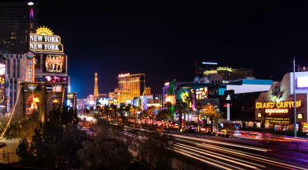 Nighttime 4K Ultra HD view of brightly lit buildings, streets, and roads in the city of Las Vegas, USA, showcasing vibrant man-made lights and urban energy.