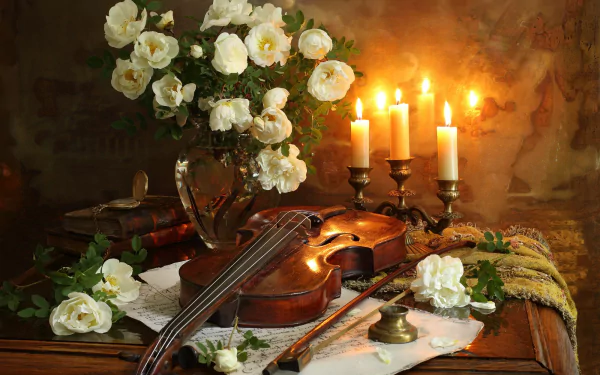 A still life HD desktop wallpaper featuring a white flower bouquet in a vase, a violin with bow, a stack of books, and lit candles creating a warm, cozy atmosphere.