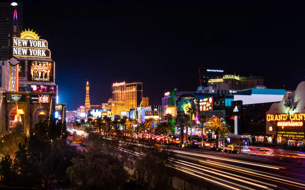 Nighttime 4K Ultra HD view of brightly lit buildings, streets, and roads in the city of Las Vegas, USA, showcasing vibrant man-made lights and urban energy.