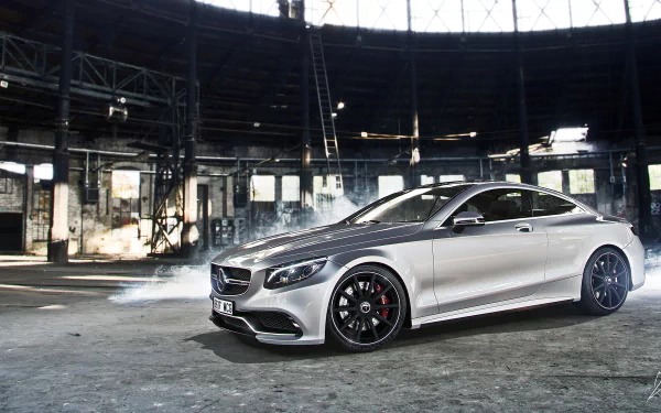 Silver Mercedes-Benz S-Class coupe showcased in a spacious industrial setting, featured as an HD PC desktop wallpaper and background.