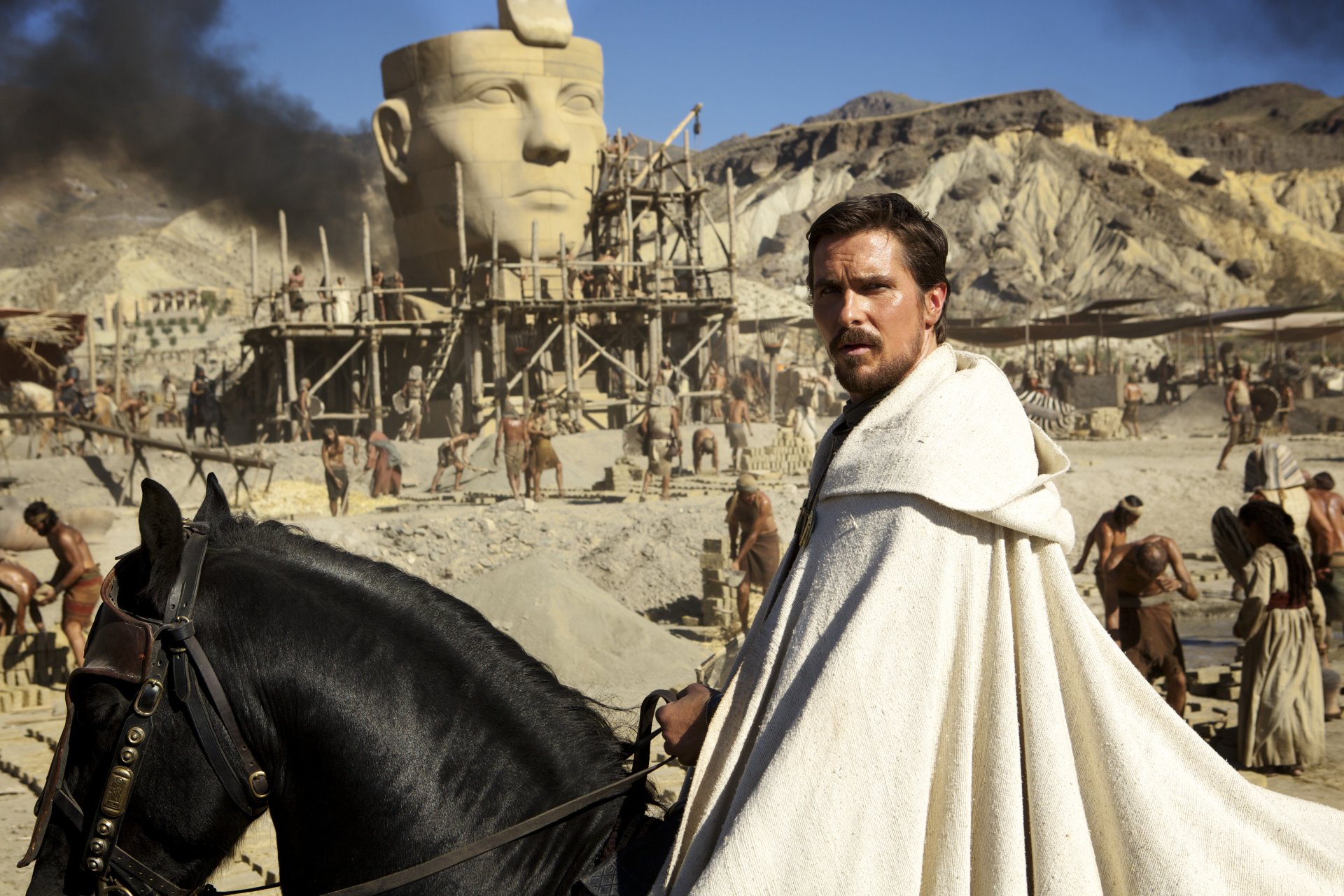 Christian Bale in a scene from the movie Exodus: Gods and Kings, set against an ancient Egyptian desert backdrop, featured in a 4K Ultra HD PC desktop wallpaper.