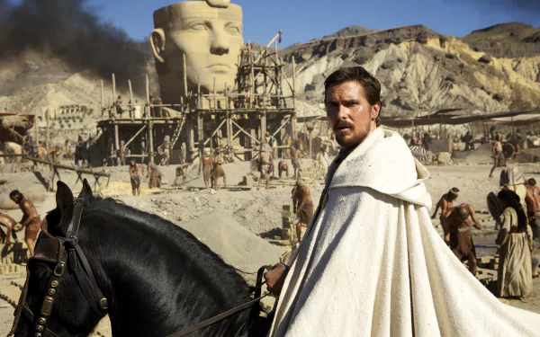 Christian Bale in a scene from the movie Exodus: Gods and Kings, set against an ancient Egyptian desert backdrop, featured in a 4K Ultra HD PC desktop wallpaper.