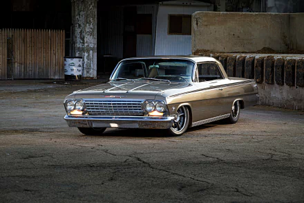 HD desktop wallpaper showcasing a classic Chevrolet Impala muscle car hot rod parked in an industrial setting.