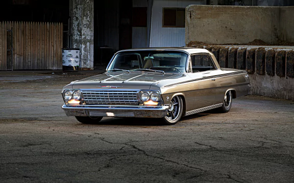 HD desktop wallpaper showcasing a classic Chevrolet Impala muscle car hot rod parked in an industrial setting.