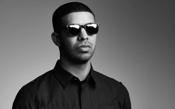 HD desktop wallpaper featuring a monochrome portrait of a man in sunglasses and a black shirt, providing a stylish background.