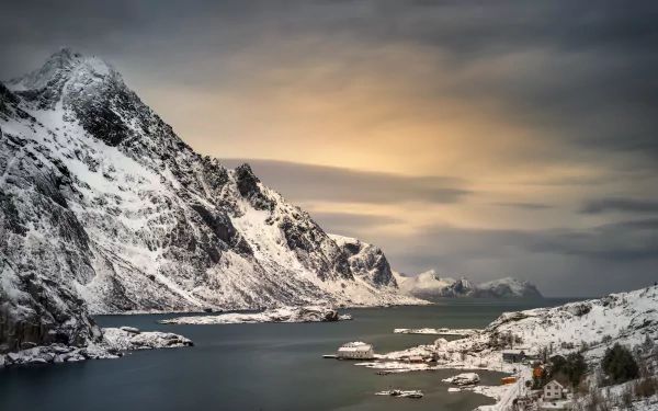 HD desktop wallpaper of a peaceful Lofoten landscape featuring snow-covered mountains beside serene waters. Perfect photography capturing the beauty of Lofoten.
