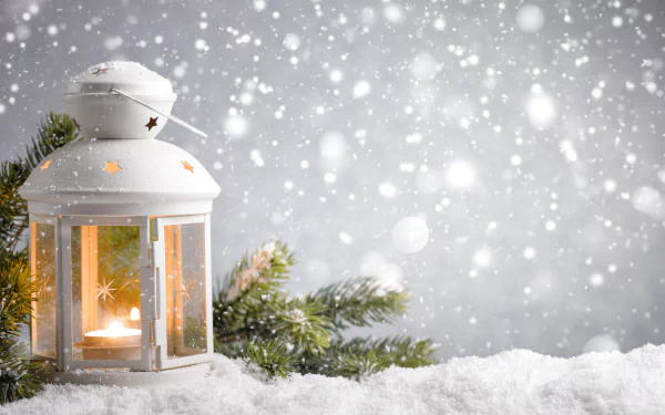 A glowing white lantern surrounded by snow and pine branches, with softly falling snowflakes, captured in 8K Ultra HD for a festive Christmas holiday PC desktop wallpaper.