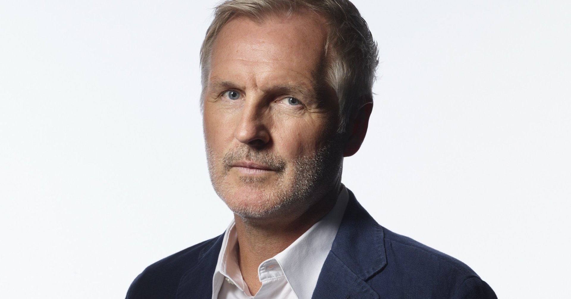 HD desktop wallpaper featuring a portrait of a man in a navy blazer and white shirt, tagged as Andrew Airlie.