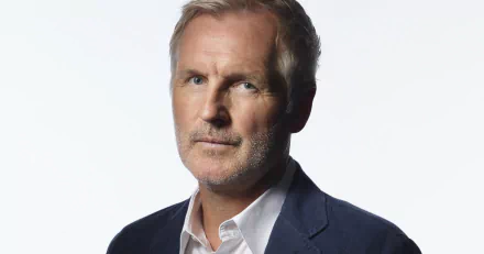 HD desktop wallpaper featuring a portrait of a man in a navy blazer and white shirt, tagged as Andrew Airlie.