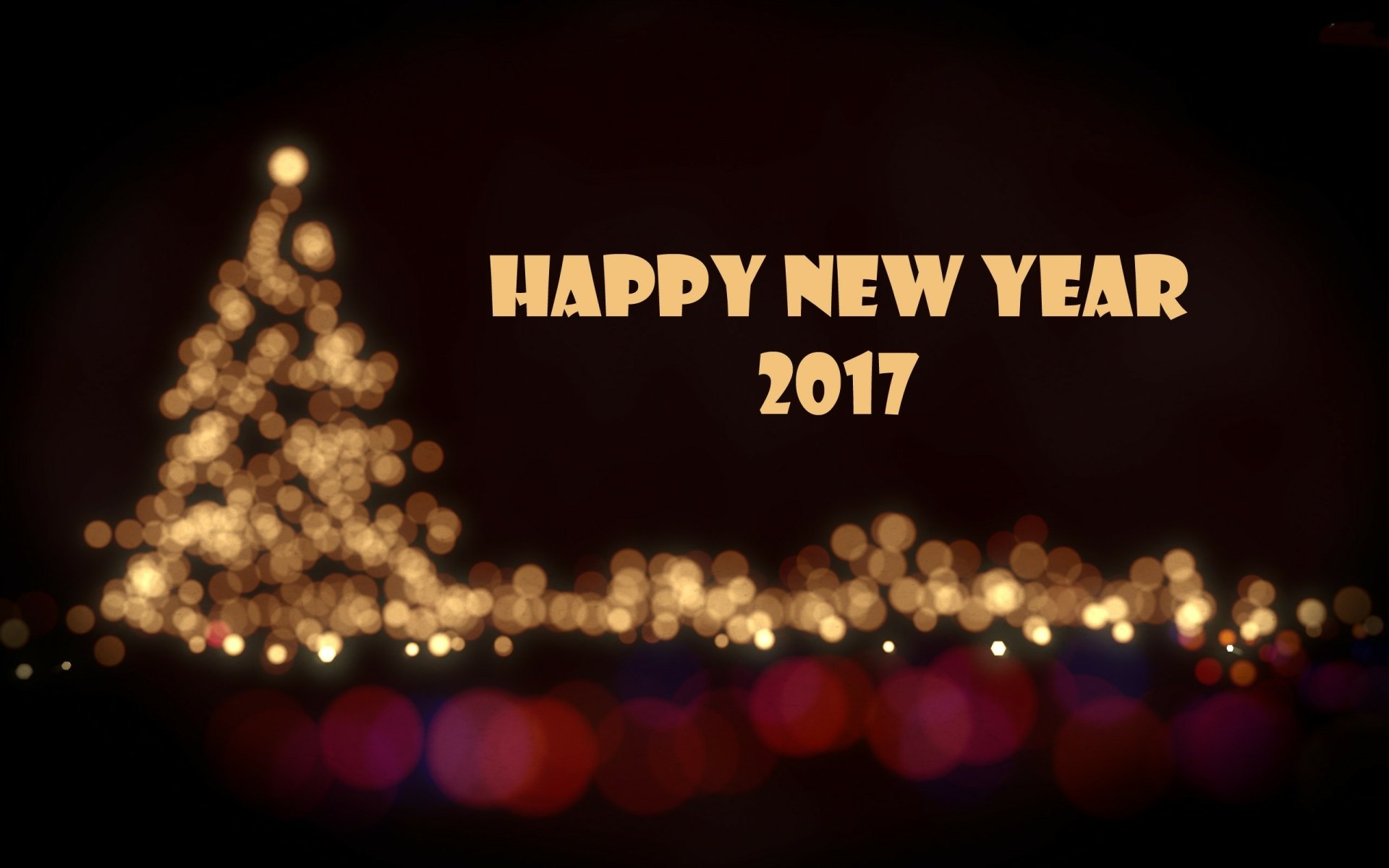 HD desktop wallpaper featuring a bokeh-lit Christmas tree with glowing holiday lights and Happy New Year 2017 text, capturing festive New Year celebration.