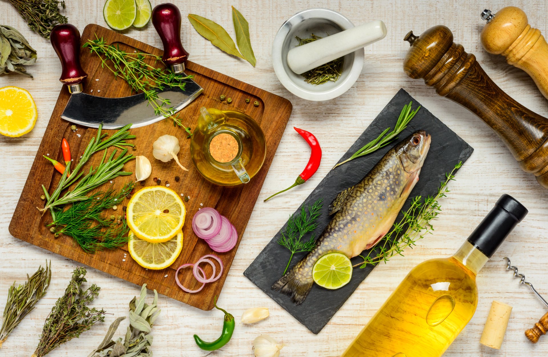 4K Ultra HD desktop wallpaper featuring a still life of a whole fish garnished with herbs and lime, surrounded by oil, spices, and fresh ingredients on a wooden surface.