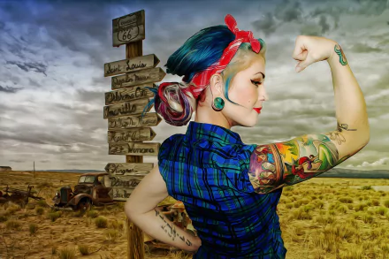 Oil-painting style pin-up woman with vibrant sleeve tattoos and red bandana flexes in a moody desert by a vintage road sign — HD PC desktop wallpaper background.