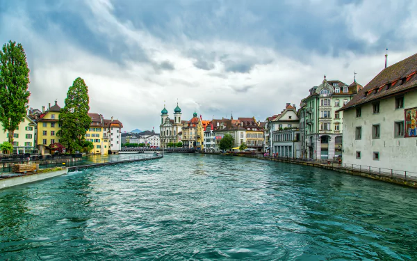 A beautiful view of the canal in Lucerne, Switzerland, featuring historic architecture and picturesque buildings along the water, captured in high definition for a stunning desktop wallpaper.