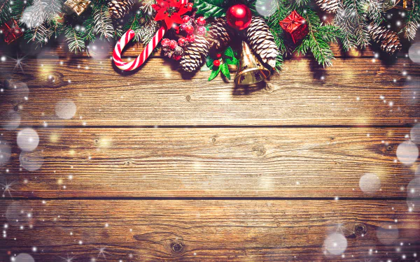 Festive Christmas decorations with pine cones, candy canes, and bells on rustic wood, captured in vibrant 4K Ultra HD for a holiday-themed PC desktop wallpaper.