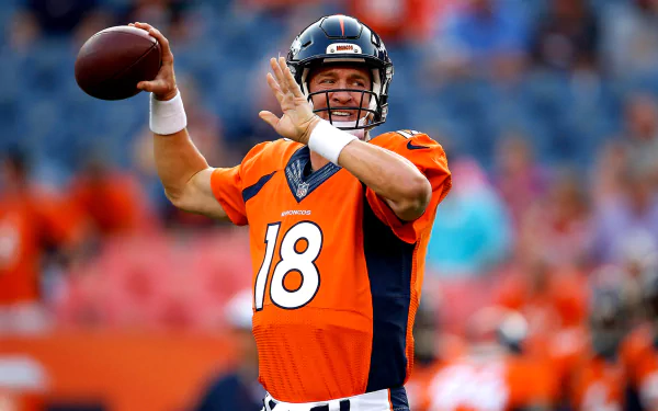 A vibrant HD desktop wallpaper featuring Peyton Manning in a Denver Broncos uniform, poised to throw a football on the field, showcasing his athletic prowess in sports.