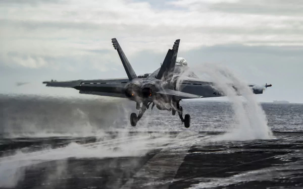 McDonnell Douglas F/A-18 Hornet warplane jet fighter landing on an aircraft carrier deck, captured in 4K Ultra HD quality.