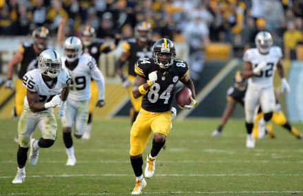 HD wallpaper featuring Antonio Brown in action on the football field, wearing a yellow and black uniform with the number 84.