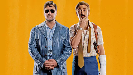 HD PC desktop wallpaper featuring Ryan Gosling and Russell Crowe from the movie The Nice Guys, set against a vibrant orange background.