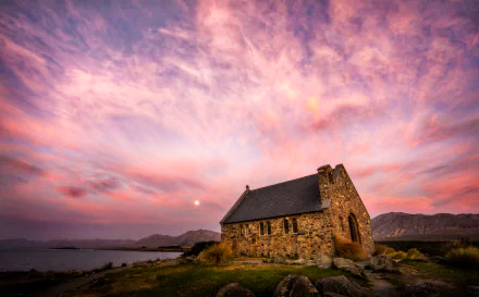 Sunset over Church of the Good Shepherd by Lake Tekapo, New Zealand, with vibrant skies and stone architecture in 4K Ultra HD.