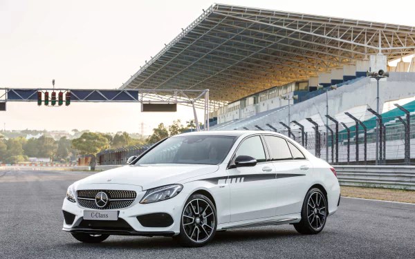 White Mercedes-Benz C-Class sedan parked on a racetrack under a grandstand, rendered in 4K Ultra HD PC desktop wallpaper/background.