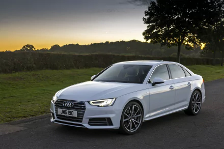 White Audi A4 sedan parked on a quiet country road at sunset, rendered as a 2K Quad HD PC desktop wallpaper and background.