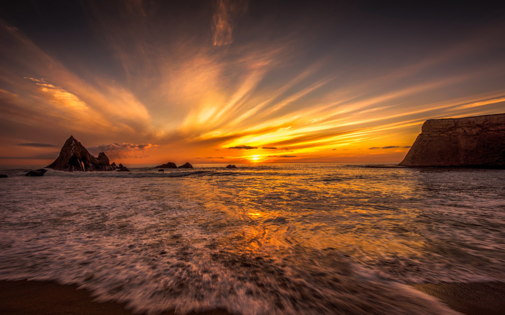 HD desktop wallpaper of a stunning beach at sunset, featuring the horizon, the vast ocean, and a vibrant sky with nature's beauty on full display.