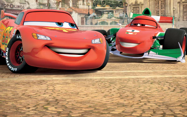 HD PC desktop wallpaper from the movie Cars 2 showing Lightning McQueen and Francesco Bernoulli racing on a sunlit cobblestone street with bright colors and animated expressions.
